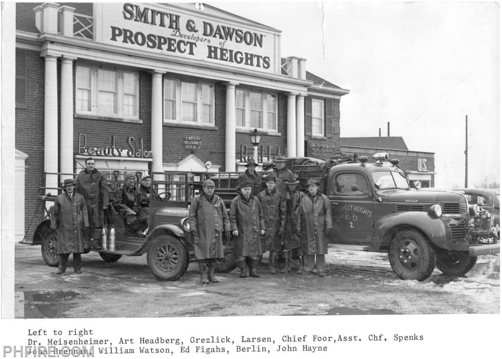 Group of firefighters in 1940s with 1926 pumper nd 1947 Dodge Darley pumper