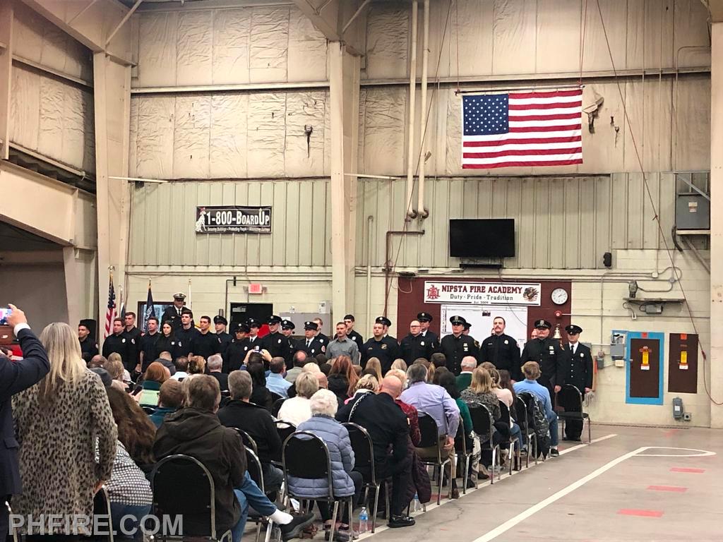 Presentation to audience of fire academy graduates at the March 10 ceremony