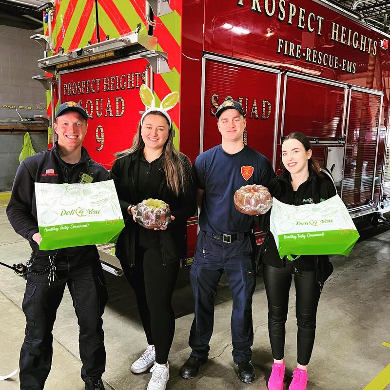 FF Murray (L) and FF Jacks (R) with two employees of Deli 4 You presenting treats