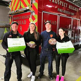FF Murray (L) and FF Jacks (R) with two employees of Deli 4 You presenting treats