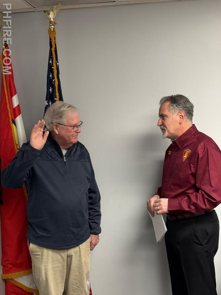 Board president Jim Rebecca administering the oath of office to new trustee Bill McDonald